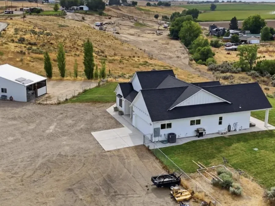 Aerial view of the single-family home and shop building at 7490 El Paso Road in Caldwell.